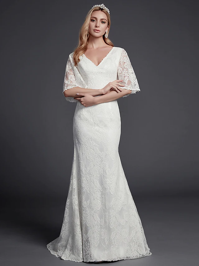 Back view of the wedding dress, highlighting the beautiful lace and open back design.