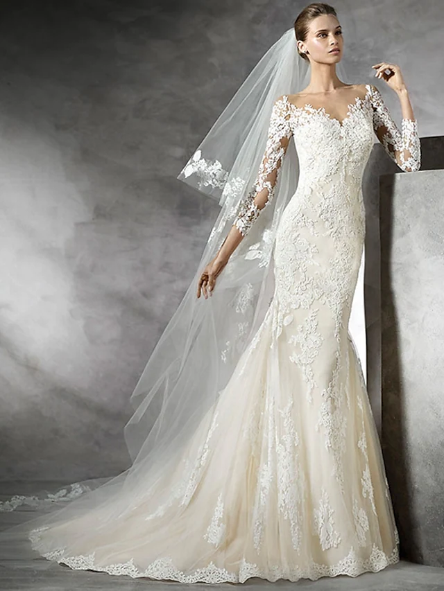 White mermaid wedding dress with V-neck and long lace illusion sleeves.