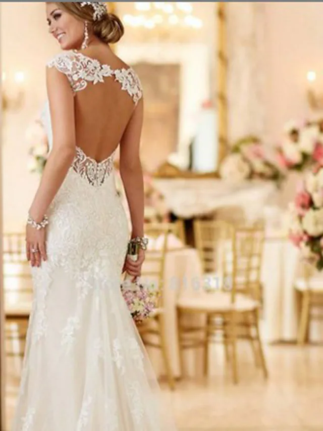 Close-up of delicate lace and V-neckline on a bridal gown.