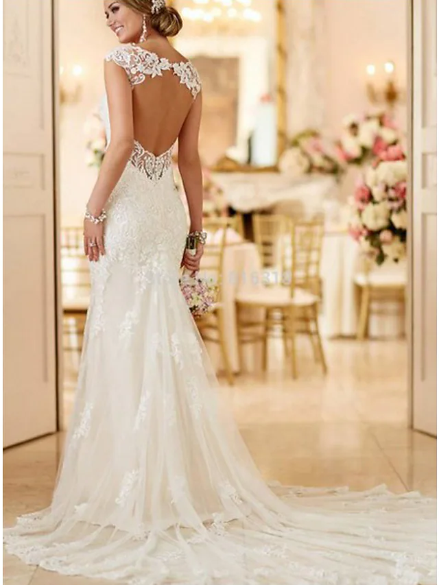 Model posing in a modern mermaid wedding dress, showcasing its flow.
