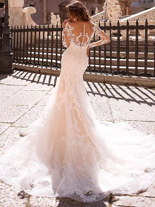 Back view of a mermaid wedding dress showing court train and lace details.