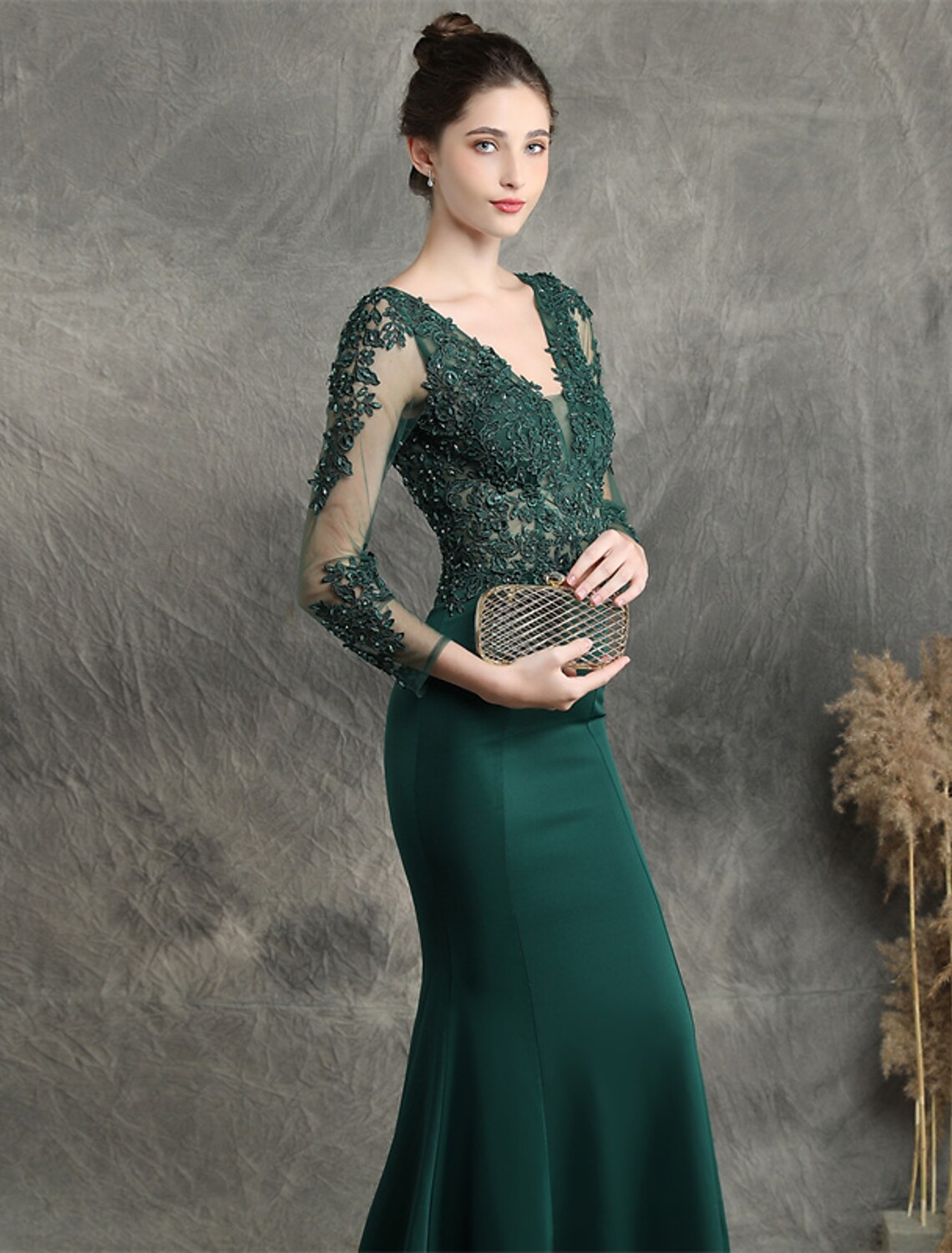 Close-up of the bodice and V-neckline of the prom dress, highlighting the intricate beading and appliques.