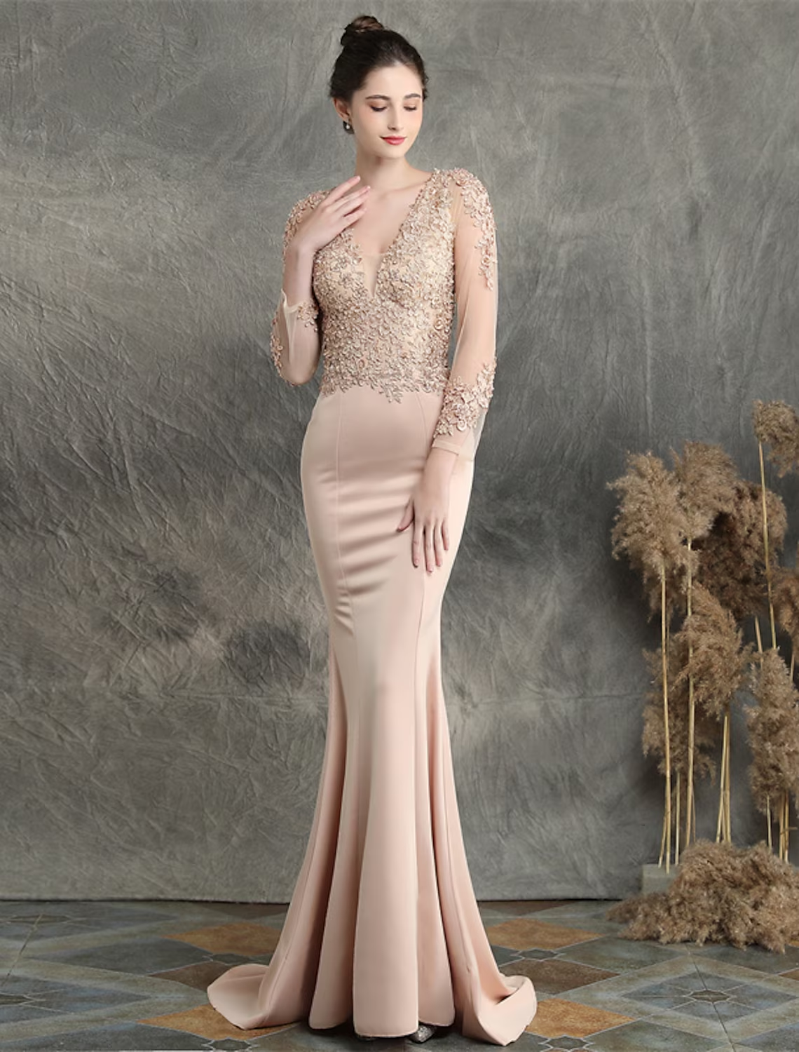 Back view of the mermaid prom dress, showing the sweep train and long sleeves.