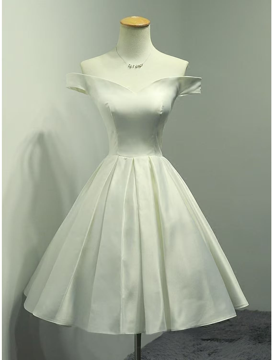 Elegant A-line off-shoulder satin cocktail dress, front view.