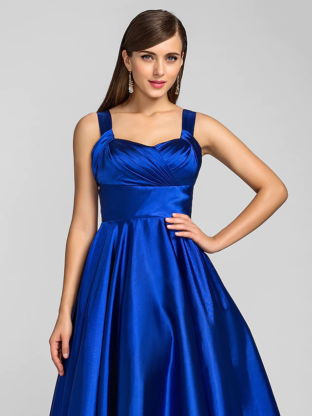Back view of A-line stretch satin dress with criss-cross detail.