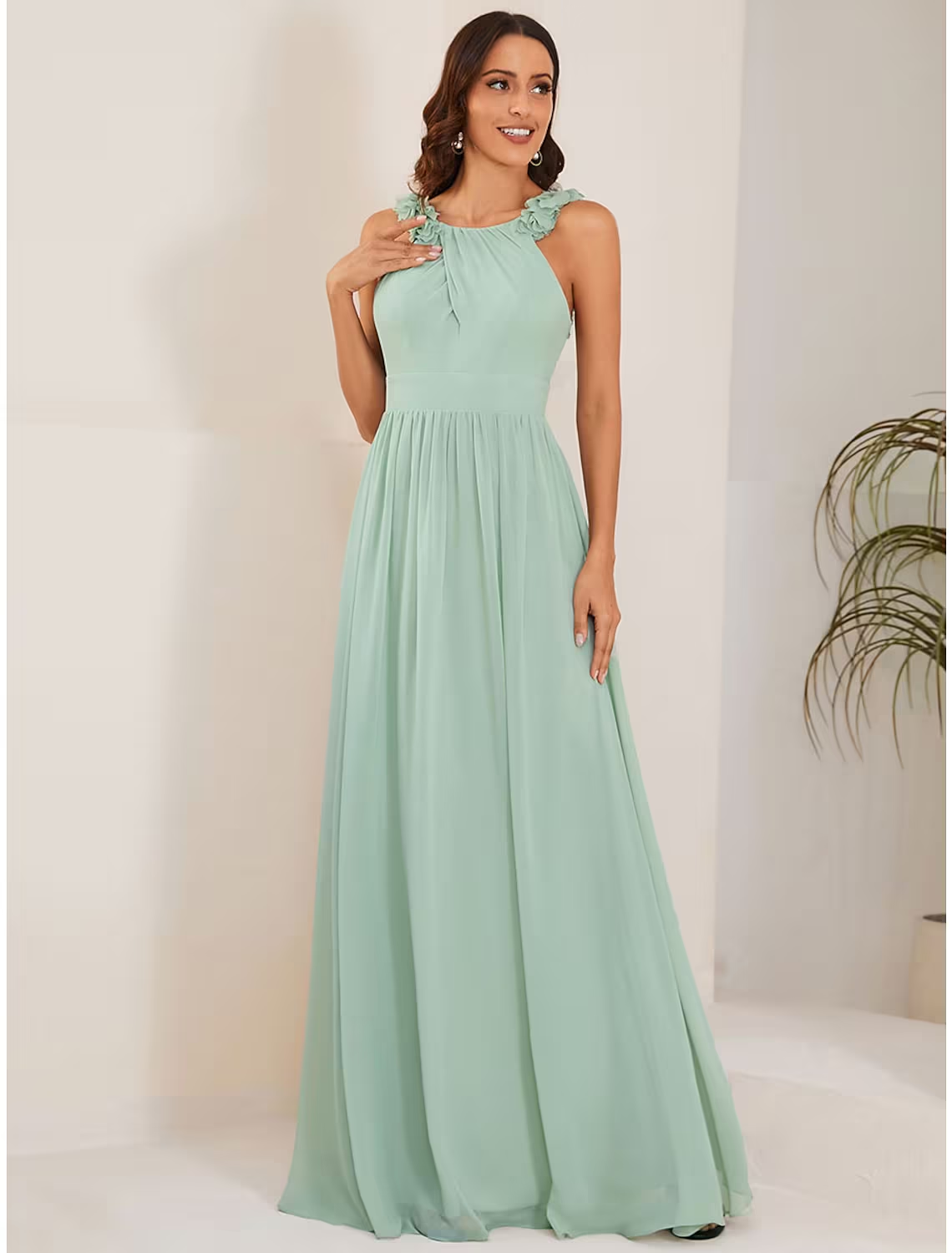 Side view of a navy A-line formal dress showing flowing chiffon fabric.