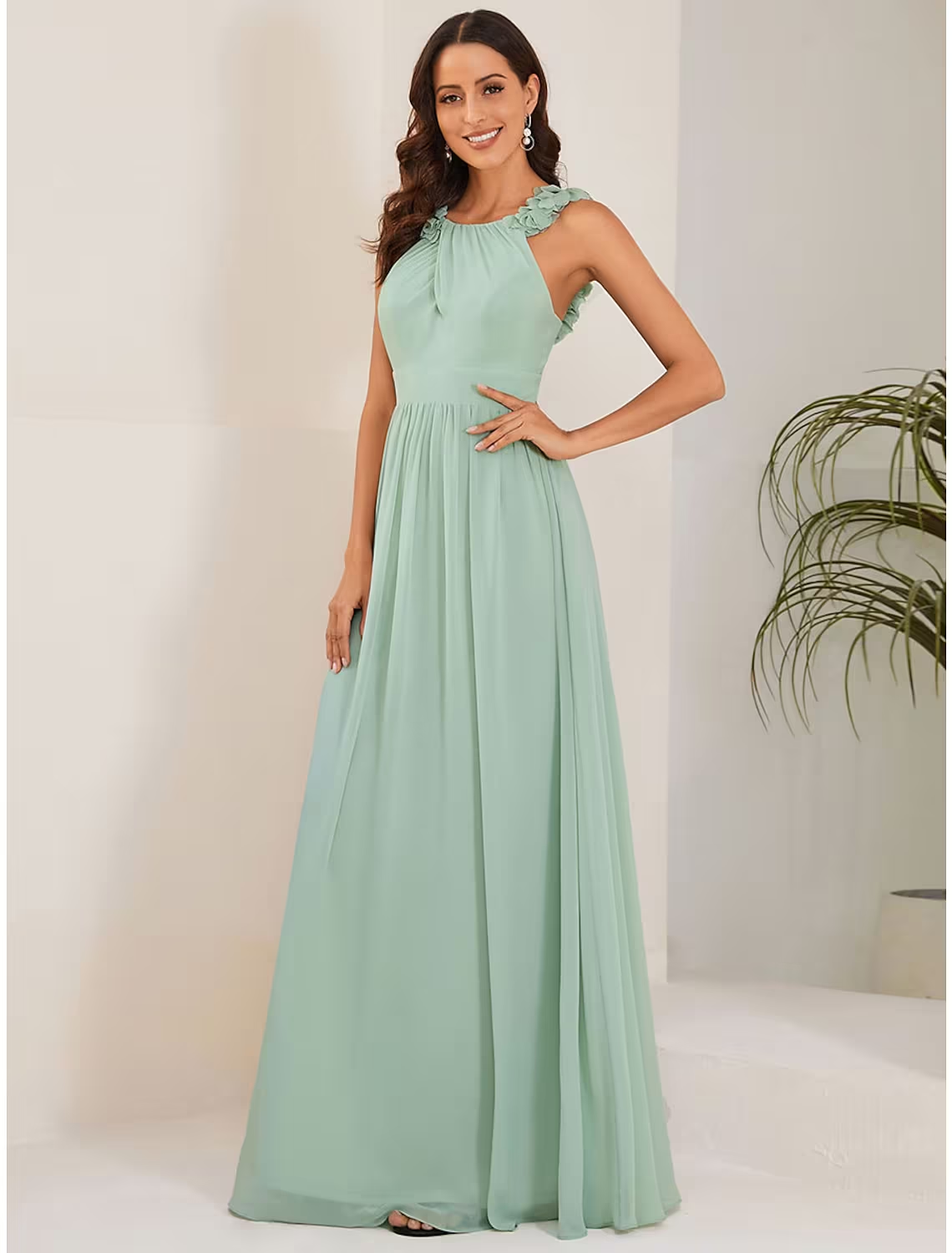 Back view of a sleeveless navy chiffon dress with a graceful drape.