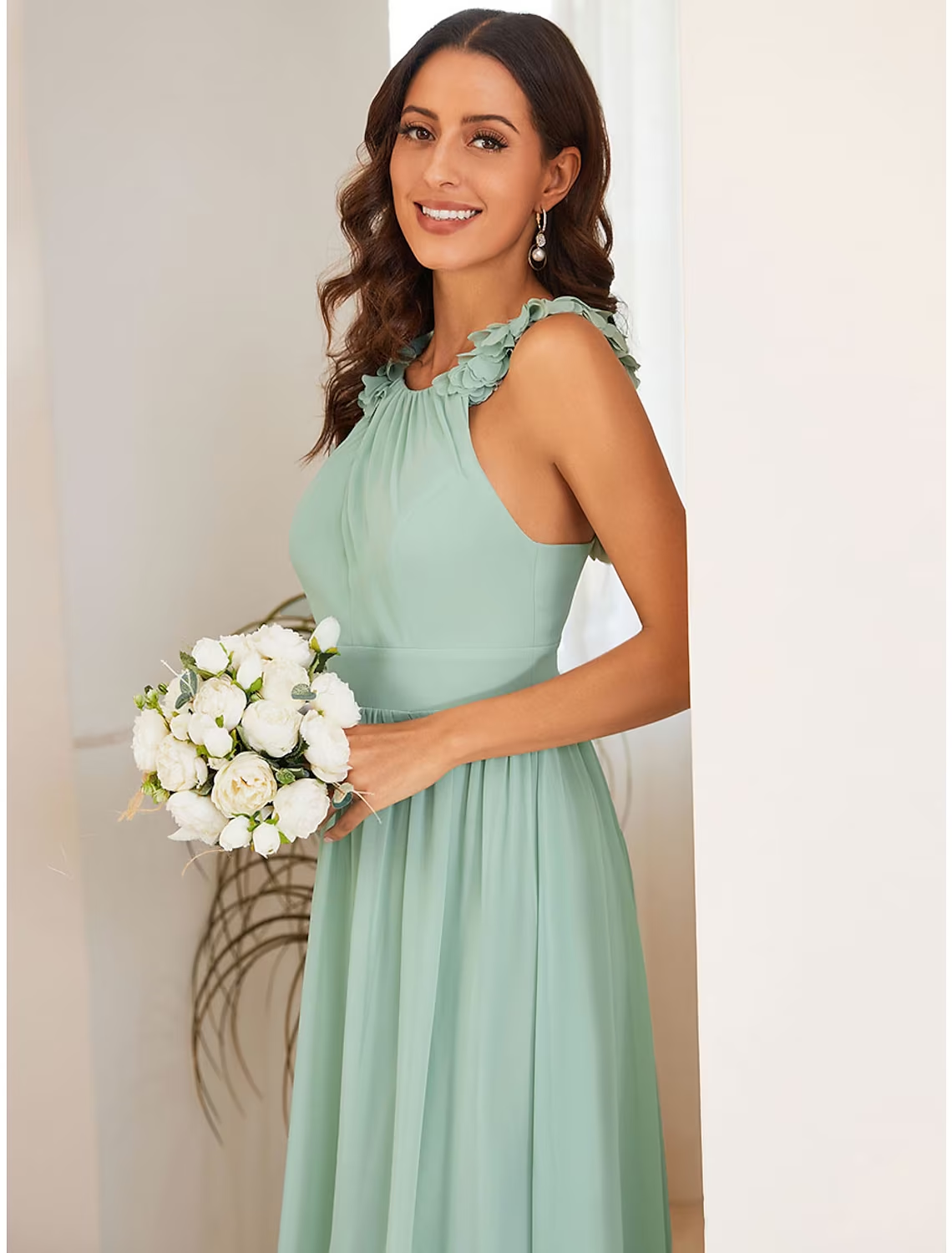 Close-up of the shoulder flower and delicate pleats on the navy formal dress.