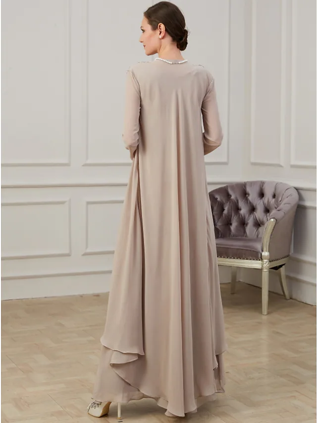 Back view of a woman in a floor-length navy A-line dress, showcasing delicate appliques.