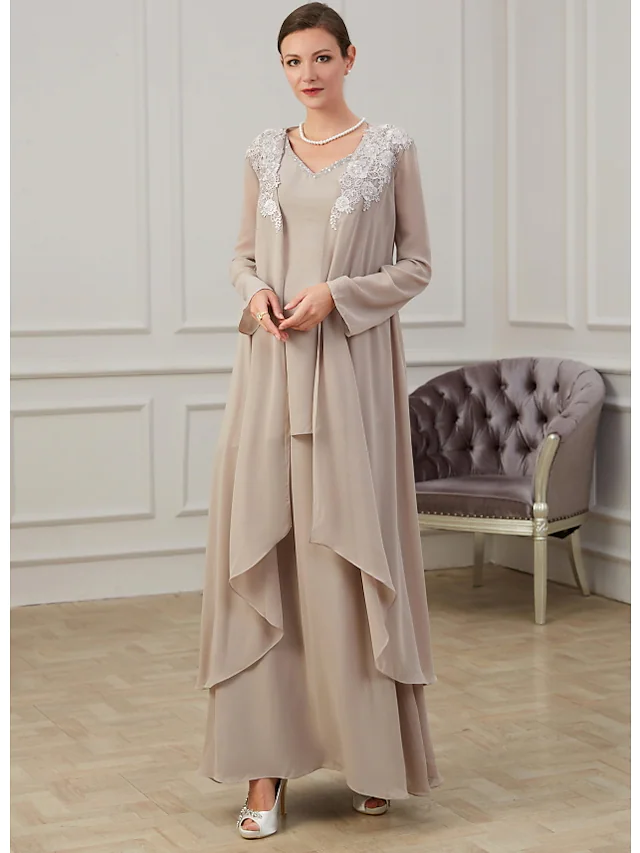 Side profile of a woman wearing a sophisticated navy long-sleeve A-line gown.