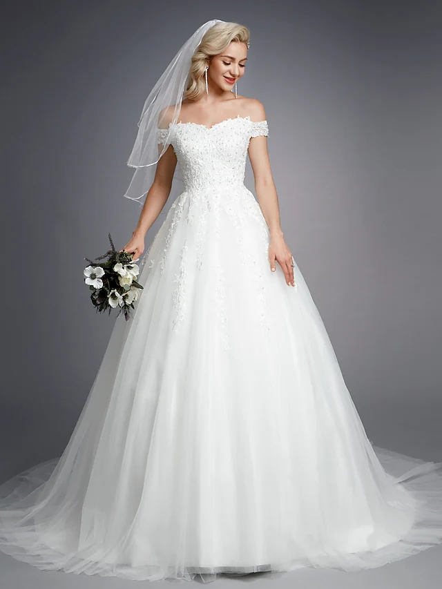 Off-shoulder ball gown wedding dress with lace and beading.