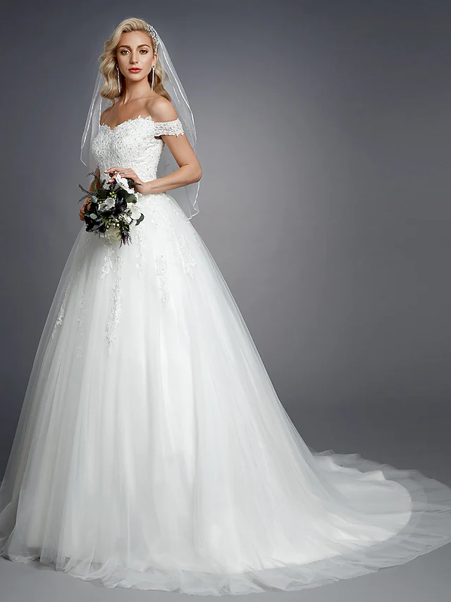 Close-up of lace and beading appliques on wedding dress.