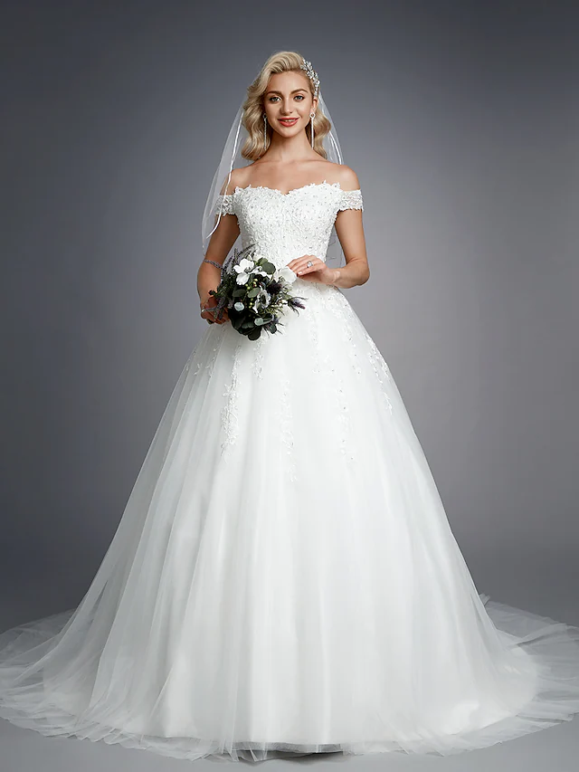 Full length view of sparkling tulle wedding dress.