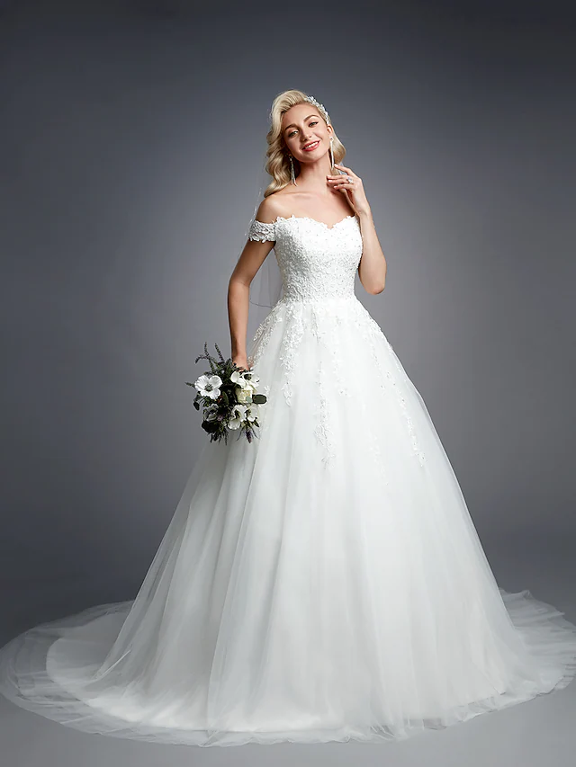 Side profile of off-shoulder bridal gown with elegant train.