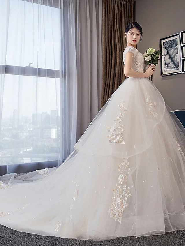 Back view of the wedding dress showing chapel train and crystal appliques.