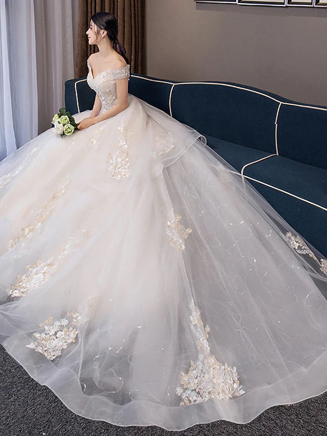 Side view of the bridal ball gown with off-shoulder neckline.
