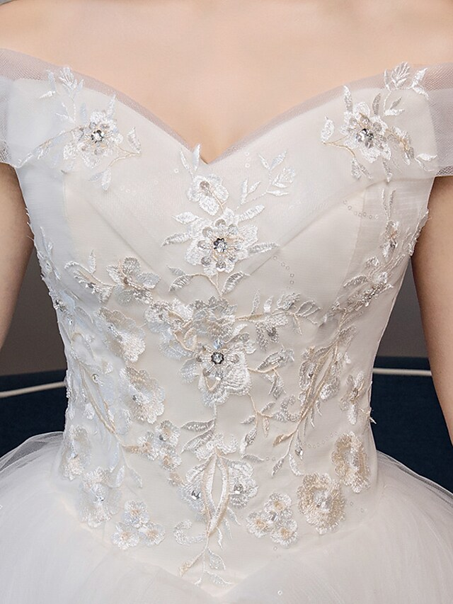 Full length view of the formal organza wedding dress.