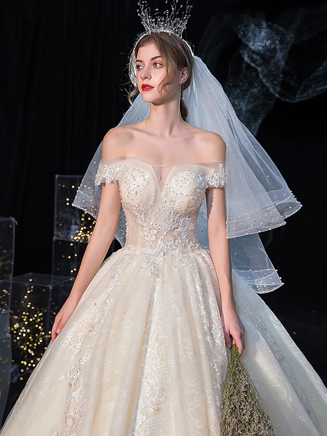 Back view of a white ball gown wedding dress showing the cathedral train.