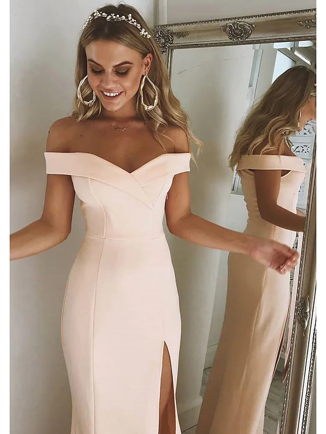 Model posing in the floor-length off-shoulder prom gown.