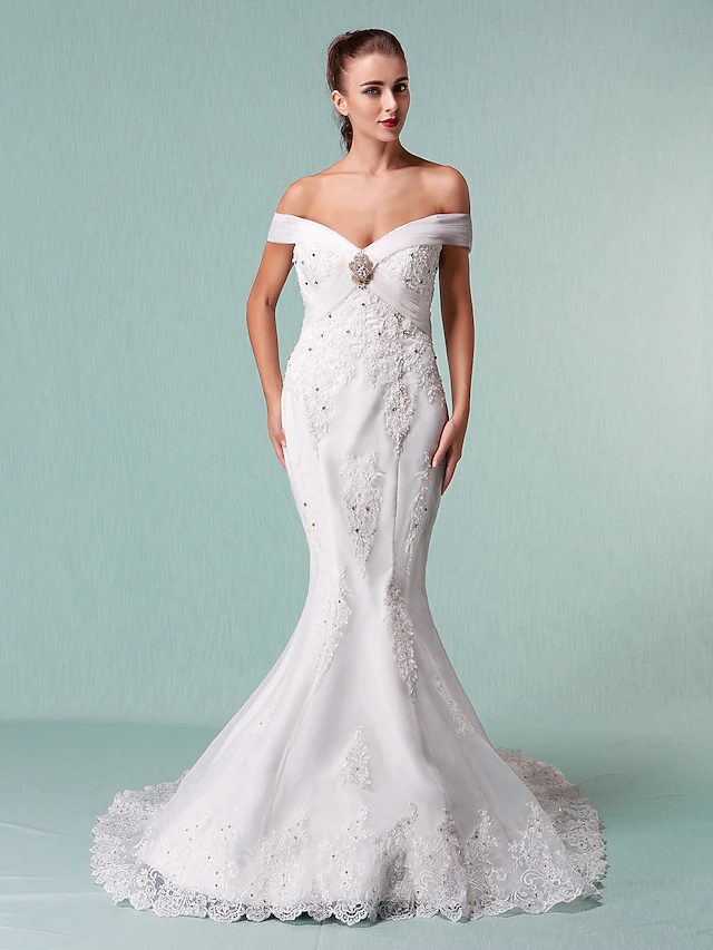 Side view of a bride wearing an off-shoulder organza wedding dress with short sleeves.