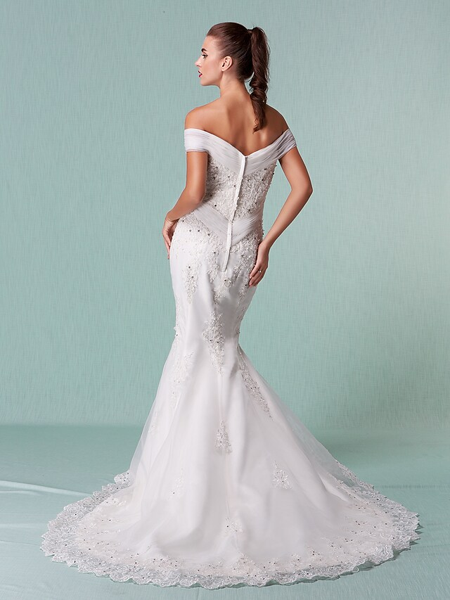 White organza wedding dress with off-shoulder design and sparkling crystal embellishments.