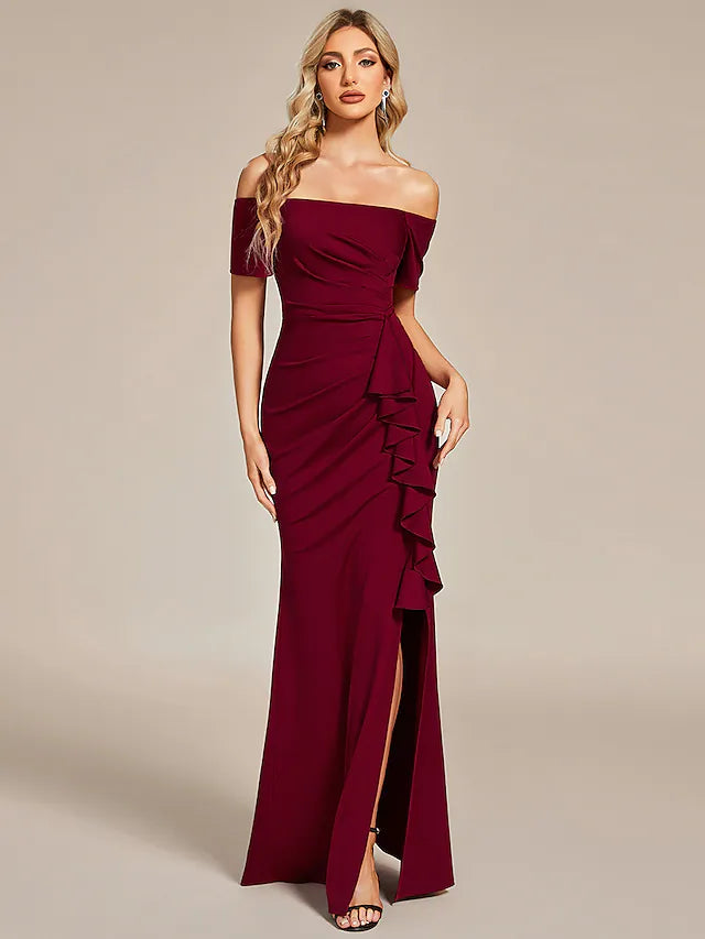 Model wearing a black off-shoulder ruched maxi dress.
