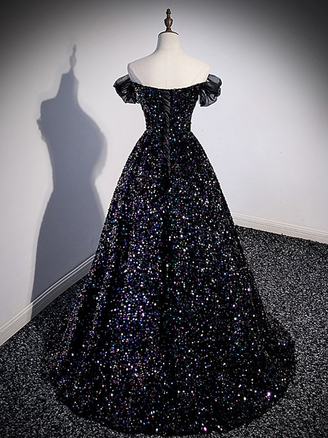 Detail of the off-shoulder neckline and sequin embellishments on the dress.