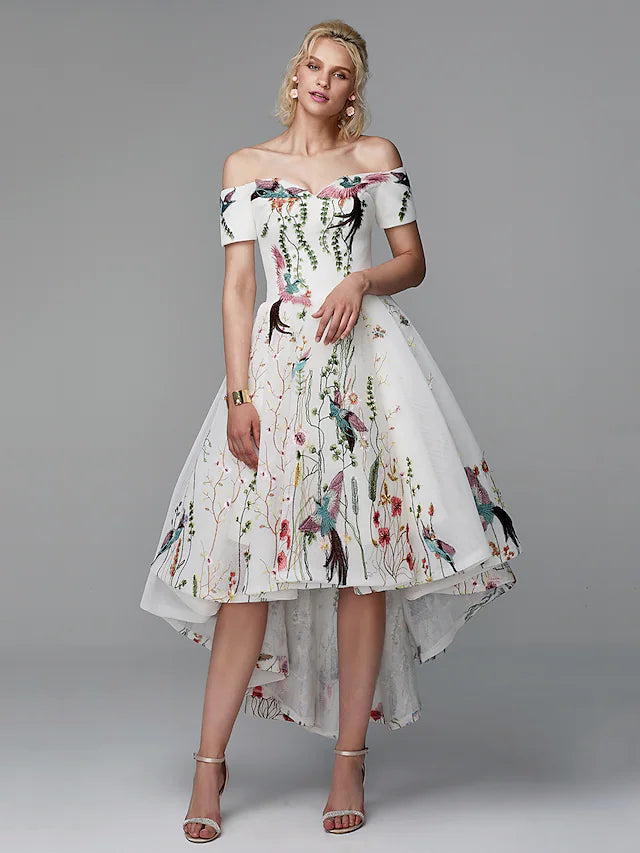 Woman wearing an elegant off-shoulder short sleeve embroidered ball gown.