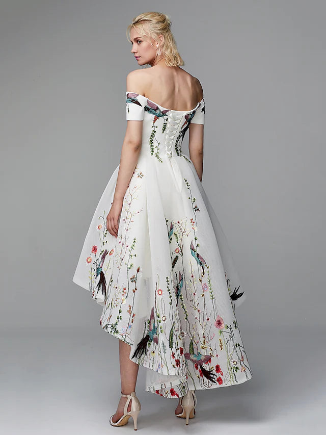 Close-up of the embroidered details on an off-shoulder ball gown.