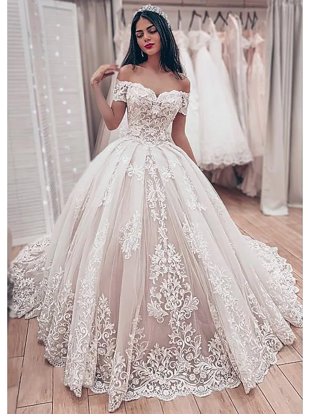 Elegant off-shoulder ball gown wedding dress with lace details and a chapel train.