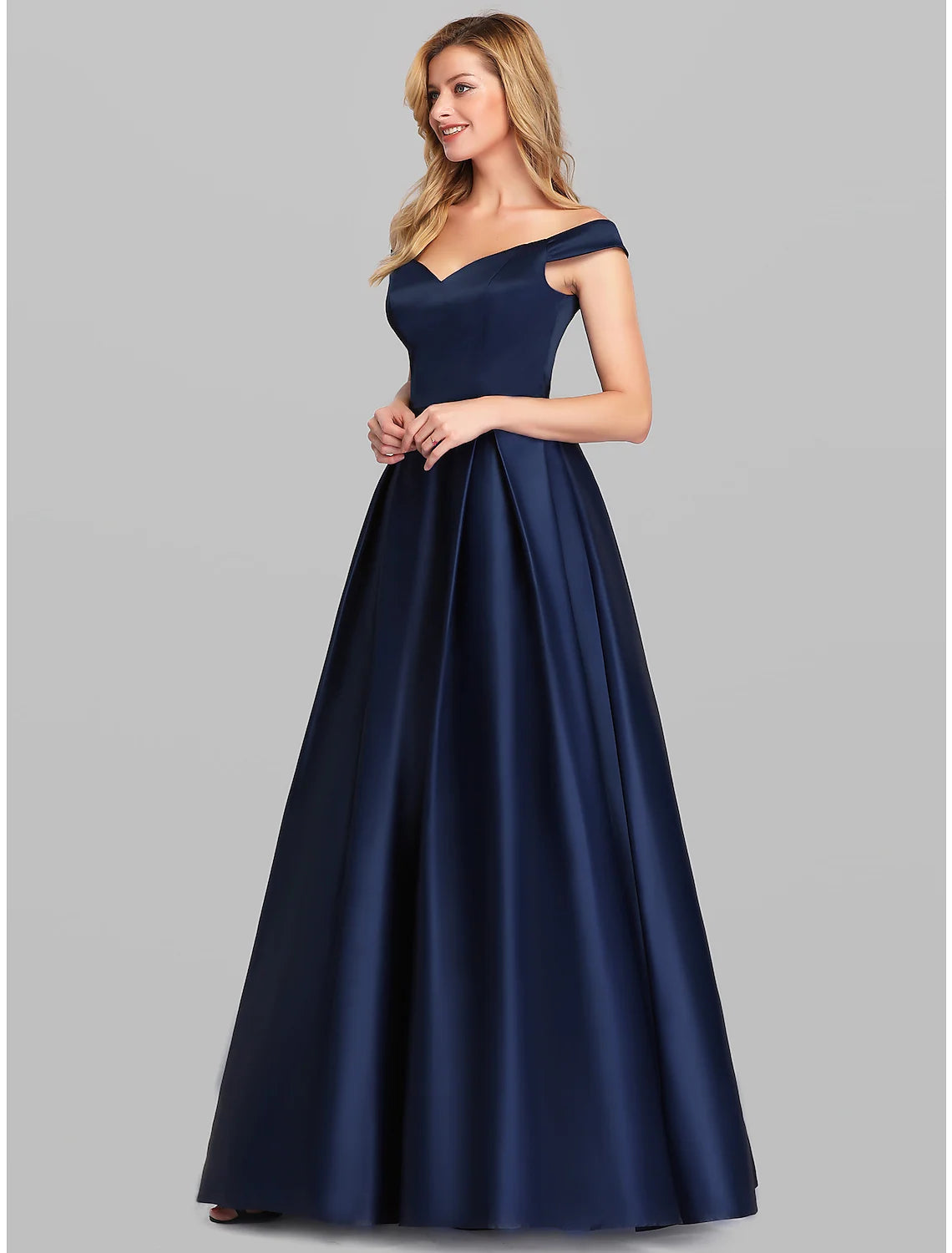 Back view of the elegant off-shoulder dress, showing pleats.