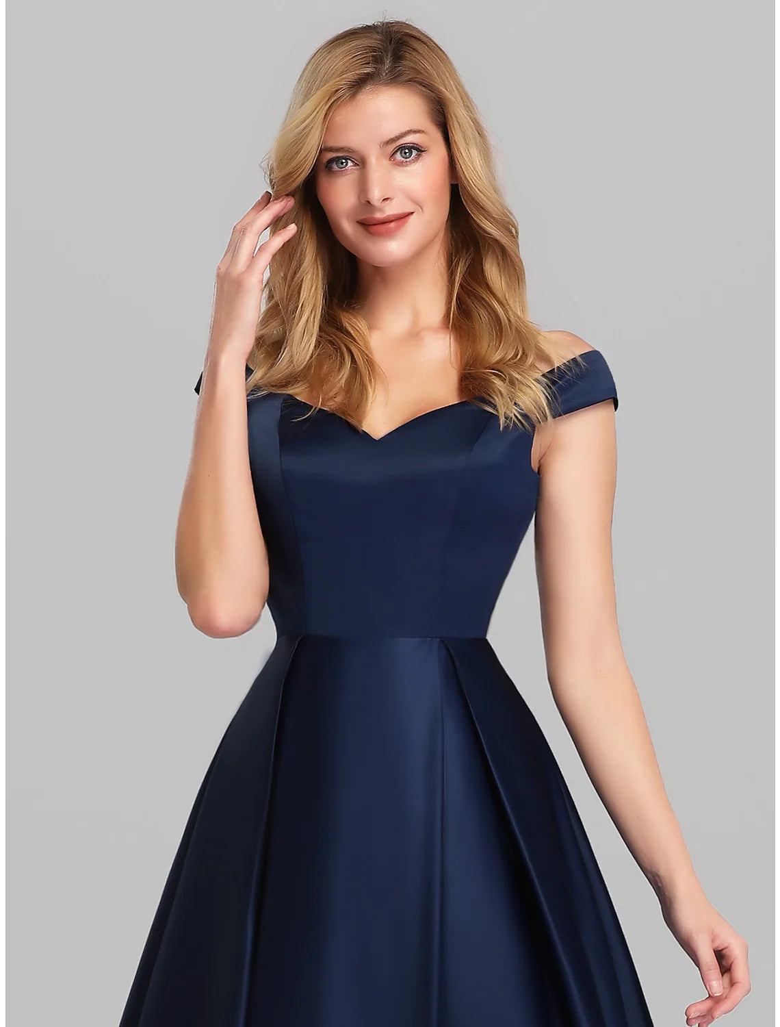 Close-up of the off-shoulder neckline and short sleeves of the satin gown.