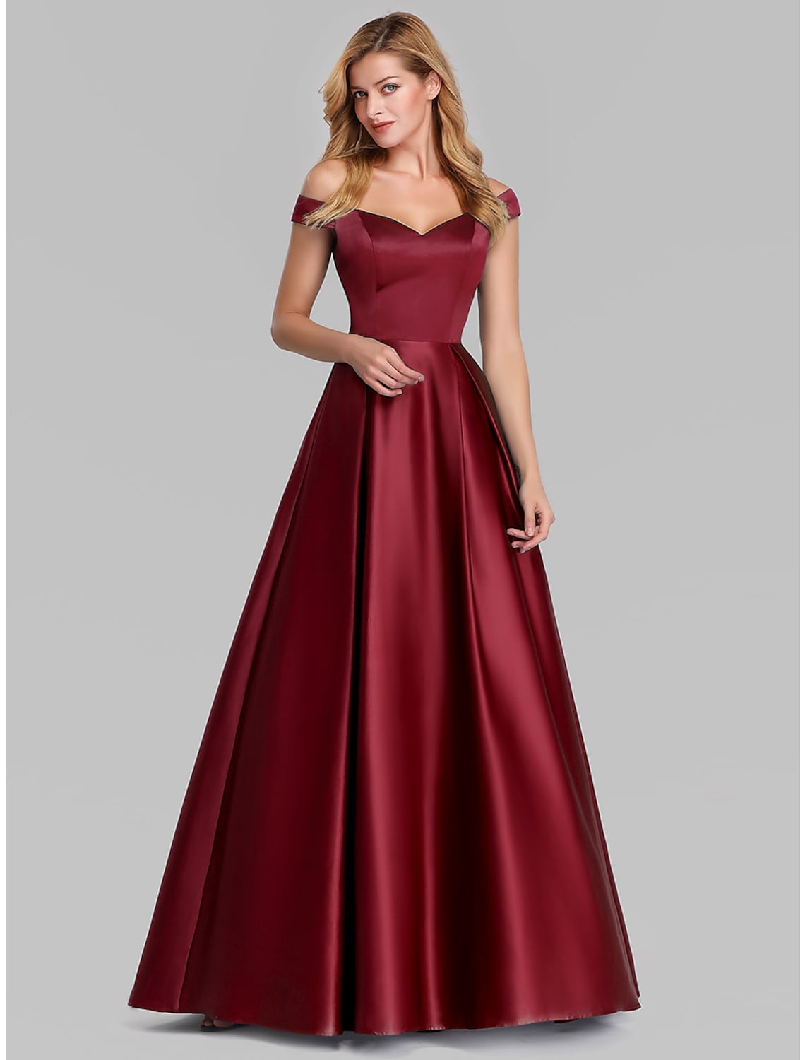 Model posing gracefully in the pleated ball gown.