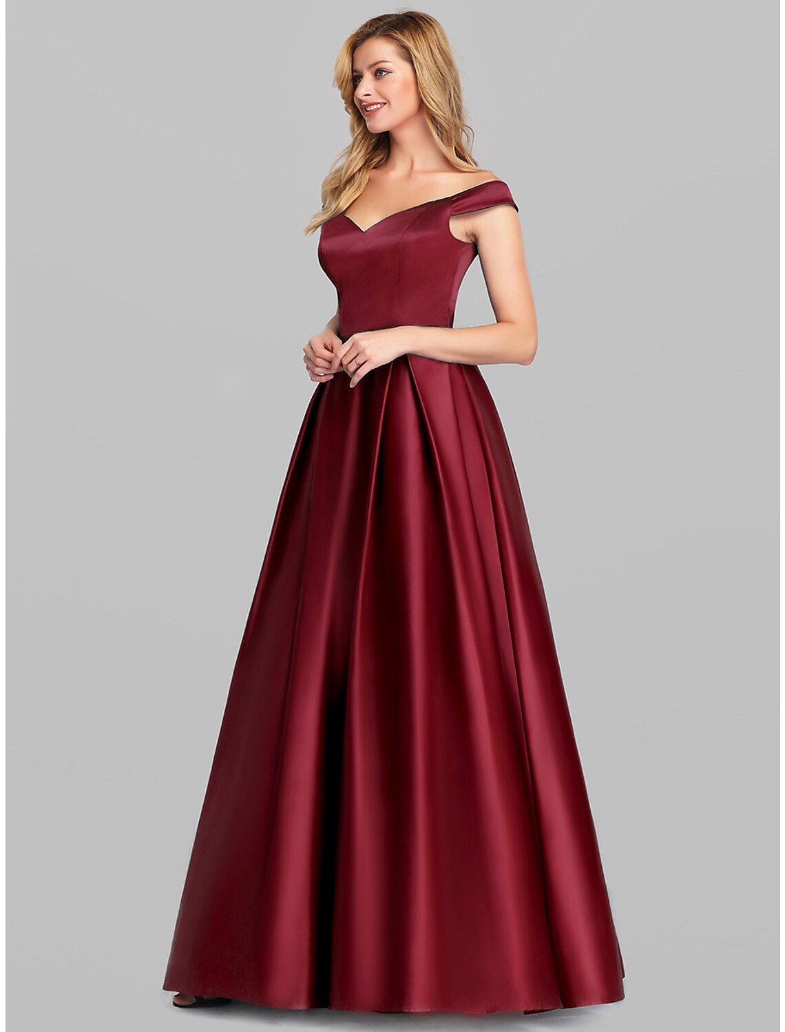 Model showcasing the full silhouette of the off-shoulder ball gown.