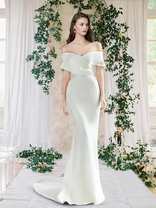 Close-up of ruched satin detail on an off-shoulder wedding dress.