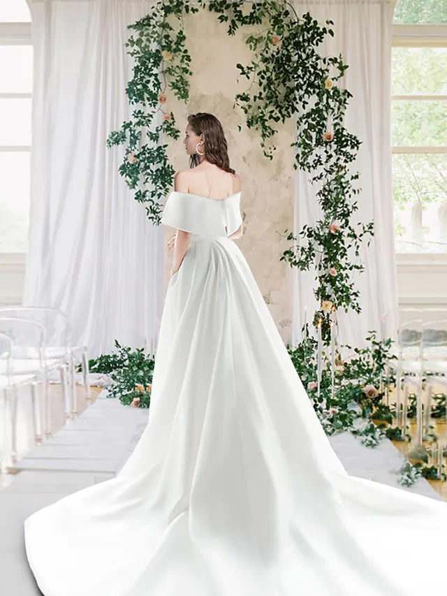 Off-shoulder short sleeve satin wedding dress with elegant draping.