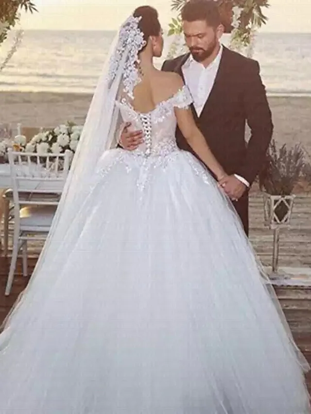 Back view of the ball gown wedding dress, highlighting the chapel train and intricate back.
