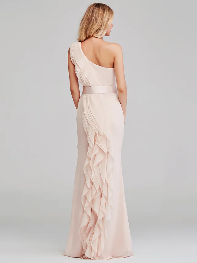 Back view of a long one-shoulder chiffon dress with flowing fabric.