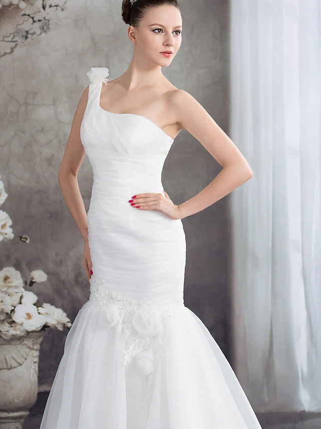 Back view of one-shoulder wedding dress showing court train and ruched details.