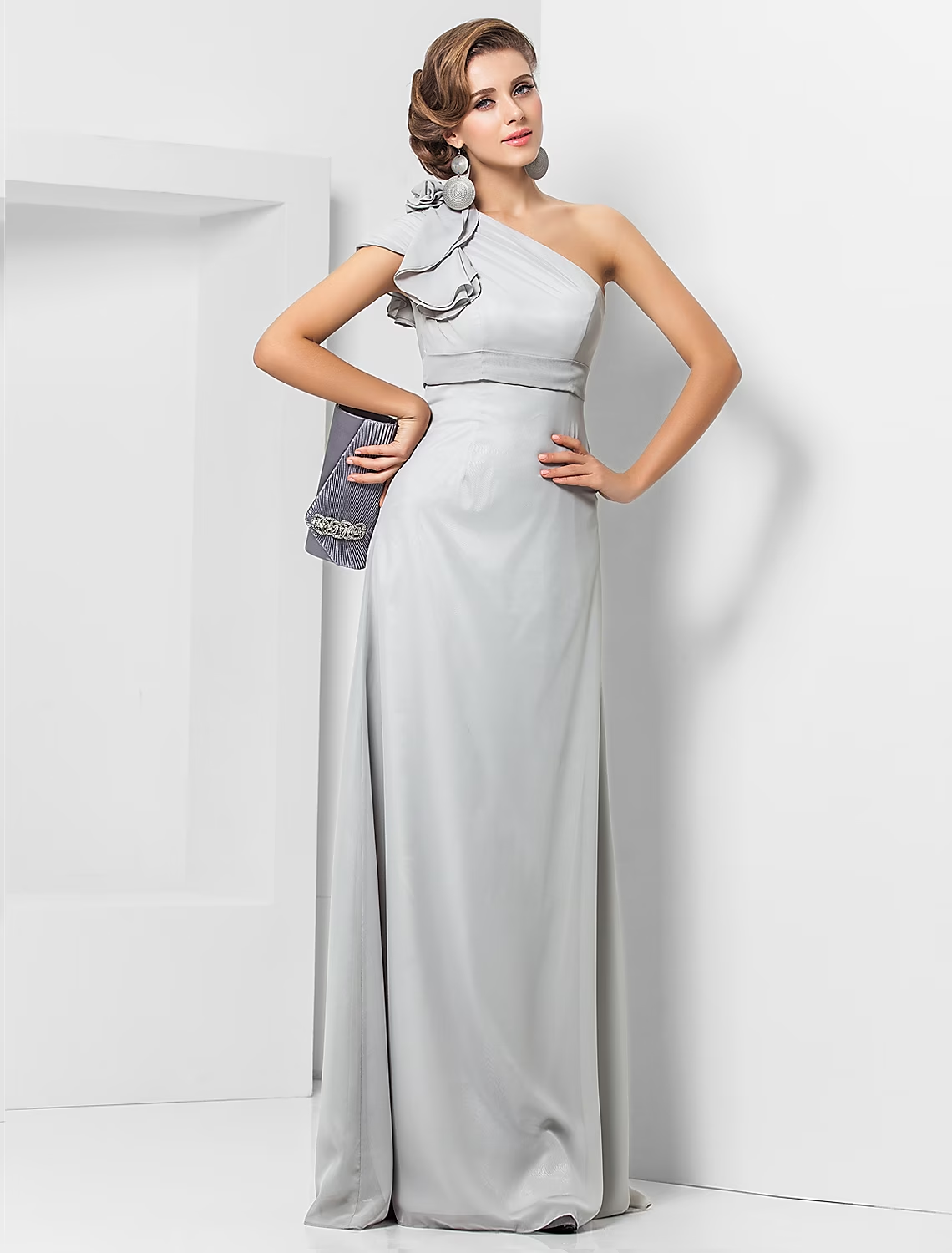 Woman wearing an elegant one-shoulder chiffon sheath gown with a sash.
