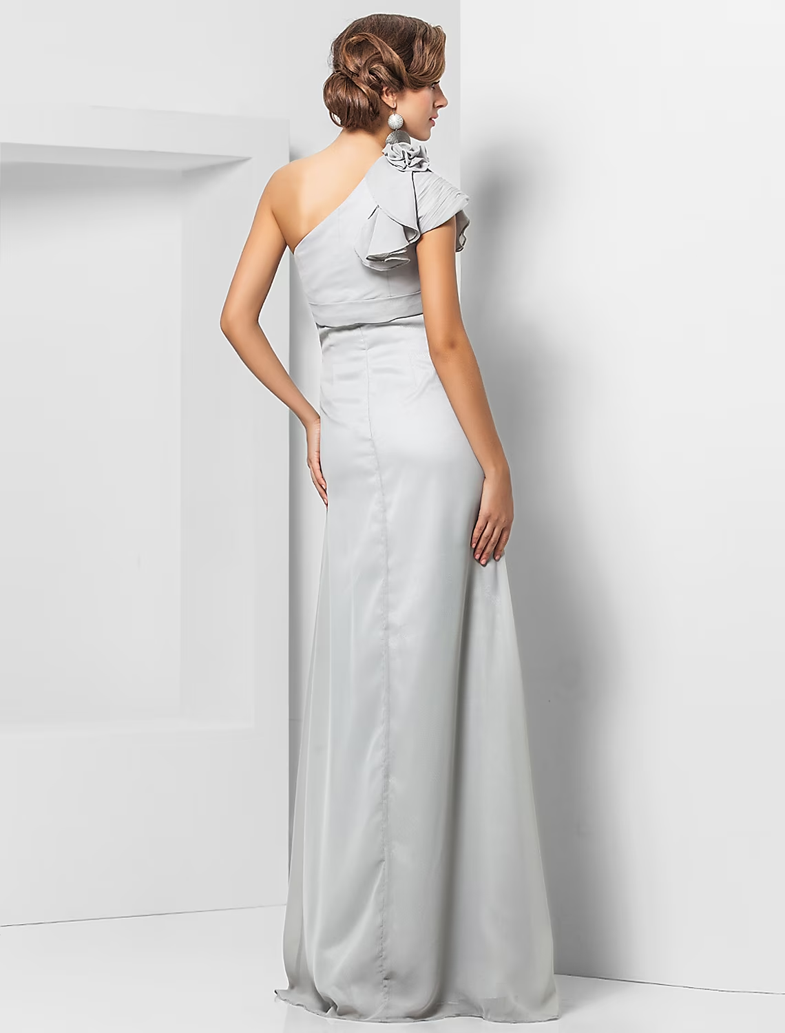 Back view of a woman in a floor-length one-shoulder formal dress.