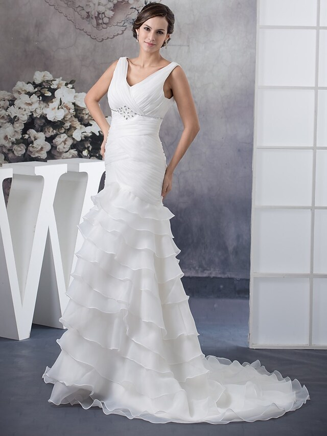 Side view of organza wedding dress showing cascading ruffles and chapel train.