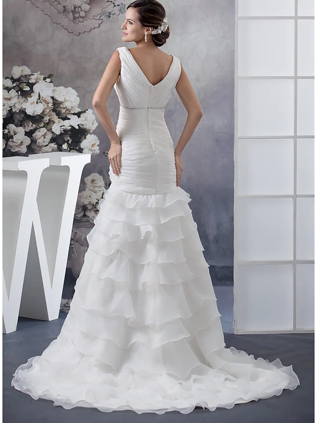 Back view of V-neck wedding dress with intricate ruched beading and long train.