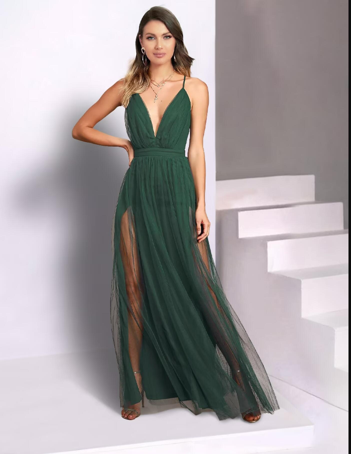 Woman wearing an elegant floor-length pleated tulle dress with spaghetti straps.