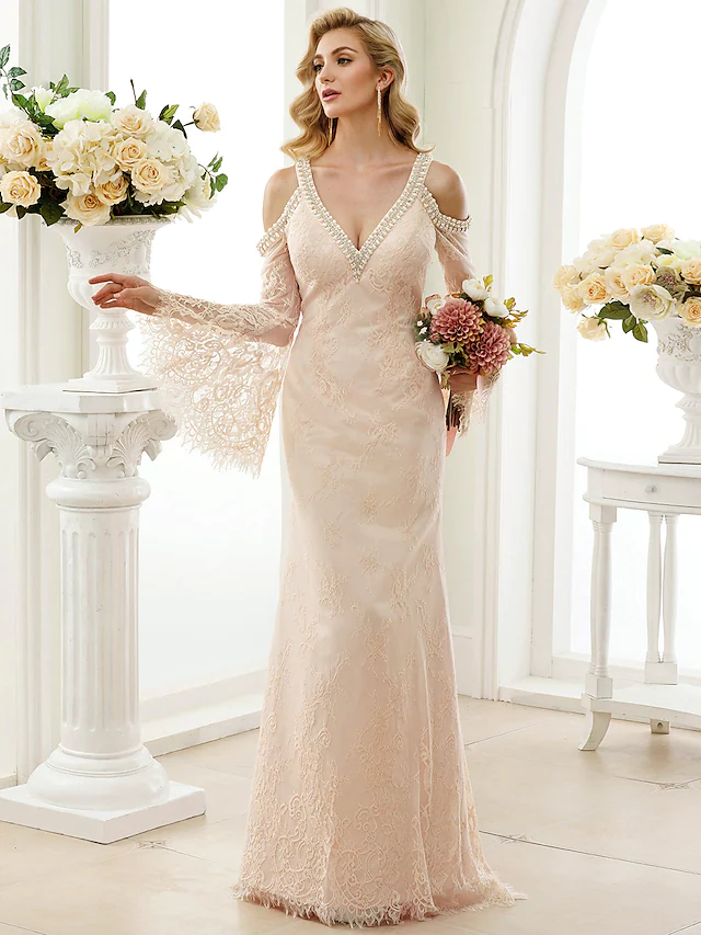 Front view of white wedding dress highlighting plunging neck and lace bodice.