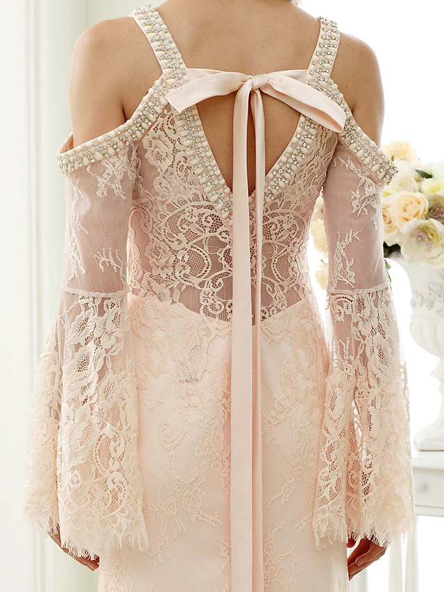 Full length view of white wedding dress with long sleeves and sweep train.