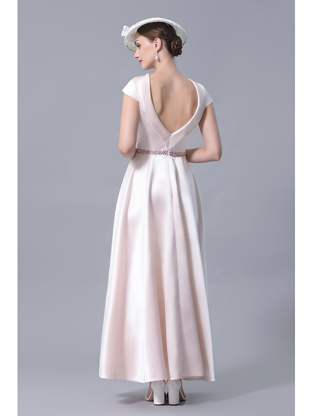 Close-up of the cowl neck and crystal embellishments on the dress.
