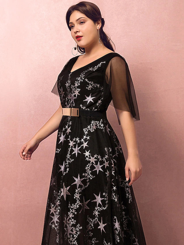 Close-up of the lace and sequin embellishments on a V-neck evening dress.