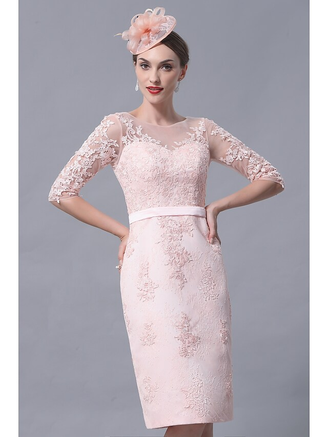 Detail shot of the bateau neckline and 3/4 lace sleeve on the dress.
