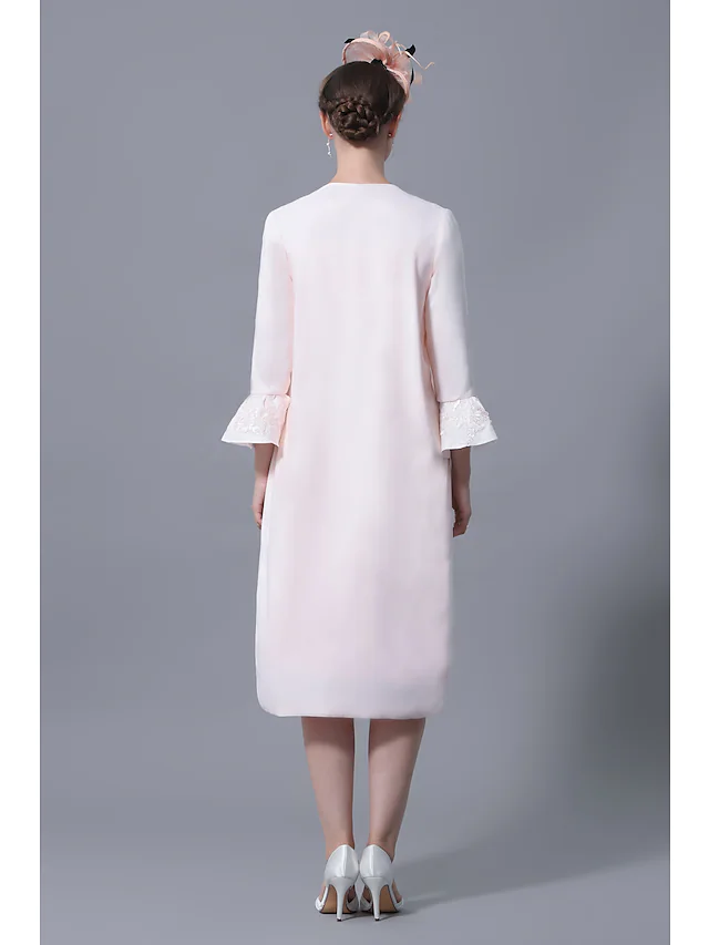 Back view of the knee-length lace Mother of the Bride dress.